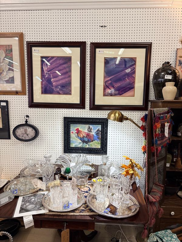 Crystal, framed art, and a brass lamp