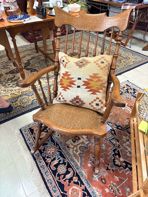 An oak rocker on an Oriental rug